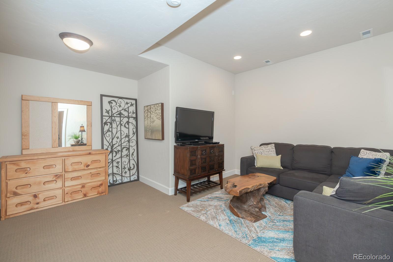 103 Timber Court Granby, CO 80446 - Photo 33 of 50 a living room with furniture and a flat screen tv