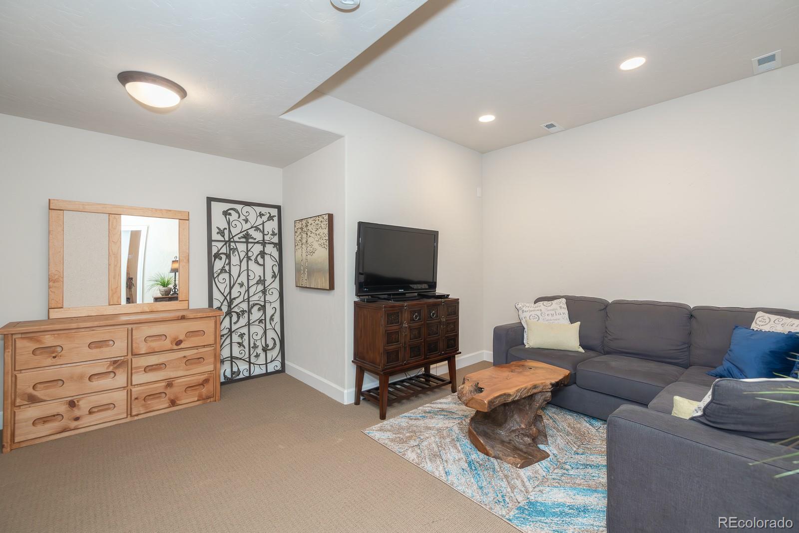 103 Timber Court Granby, CO 80446 - Photo 35 of 50 a living room with furniture and a flat screen tv