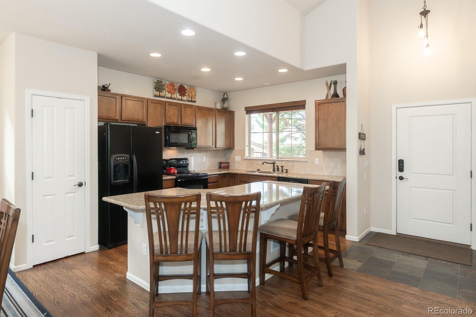 103 Timber Court Granby, CO 80446 - Photo 6 of 50 a kitchen with a table chairs refrigerator and window