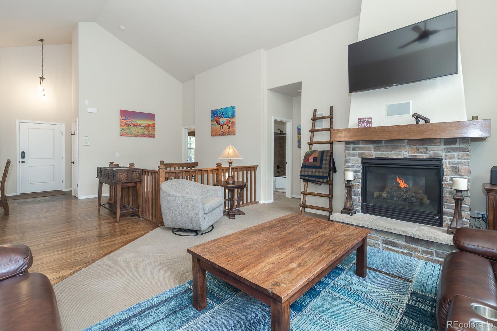 103 Timber Court Granby, CO 80446 - Photo 10 of 50 a living room with furniture a flat screen tv and a fireplace