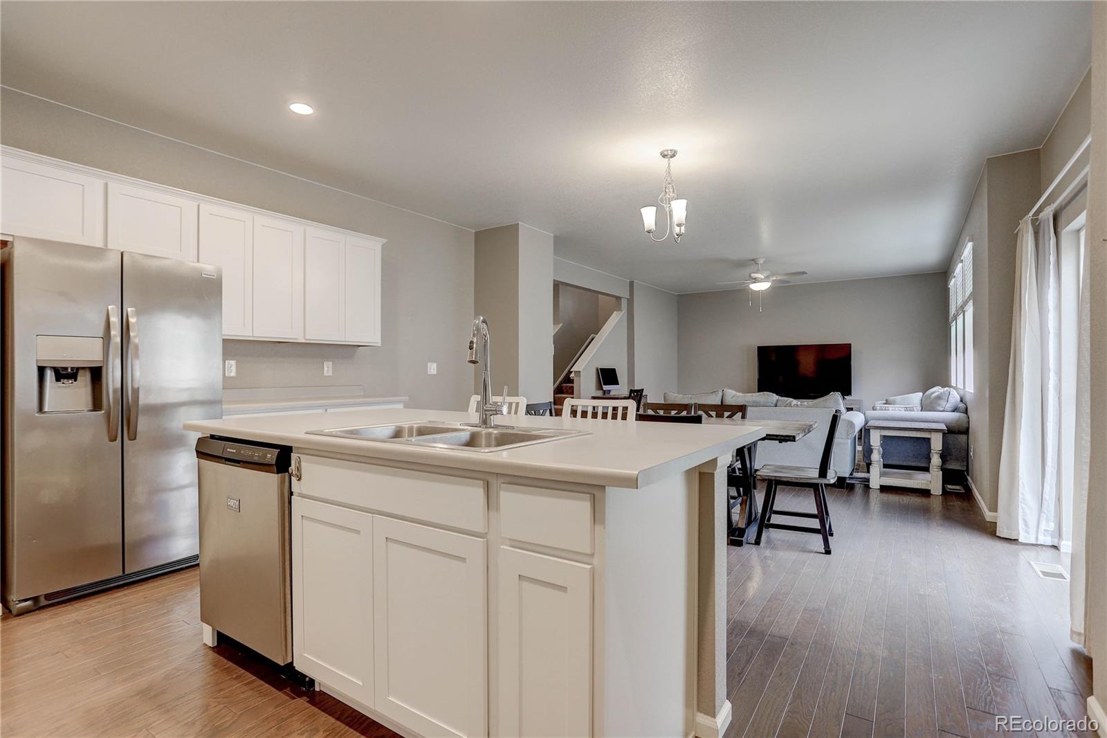 7104 Morrison Drive Frederick, CO 80530 - Photo 11 of 33 a kitchen with sink cabinets and wooden floor