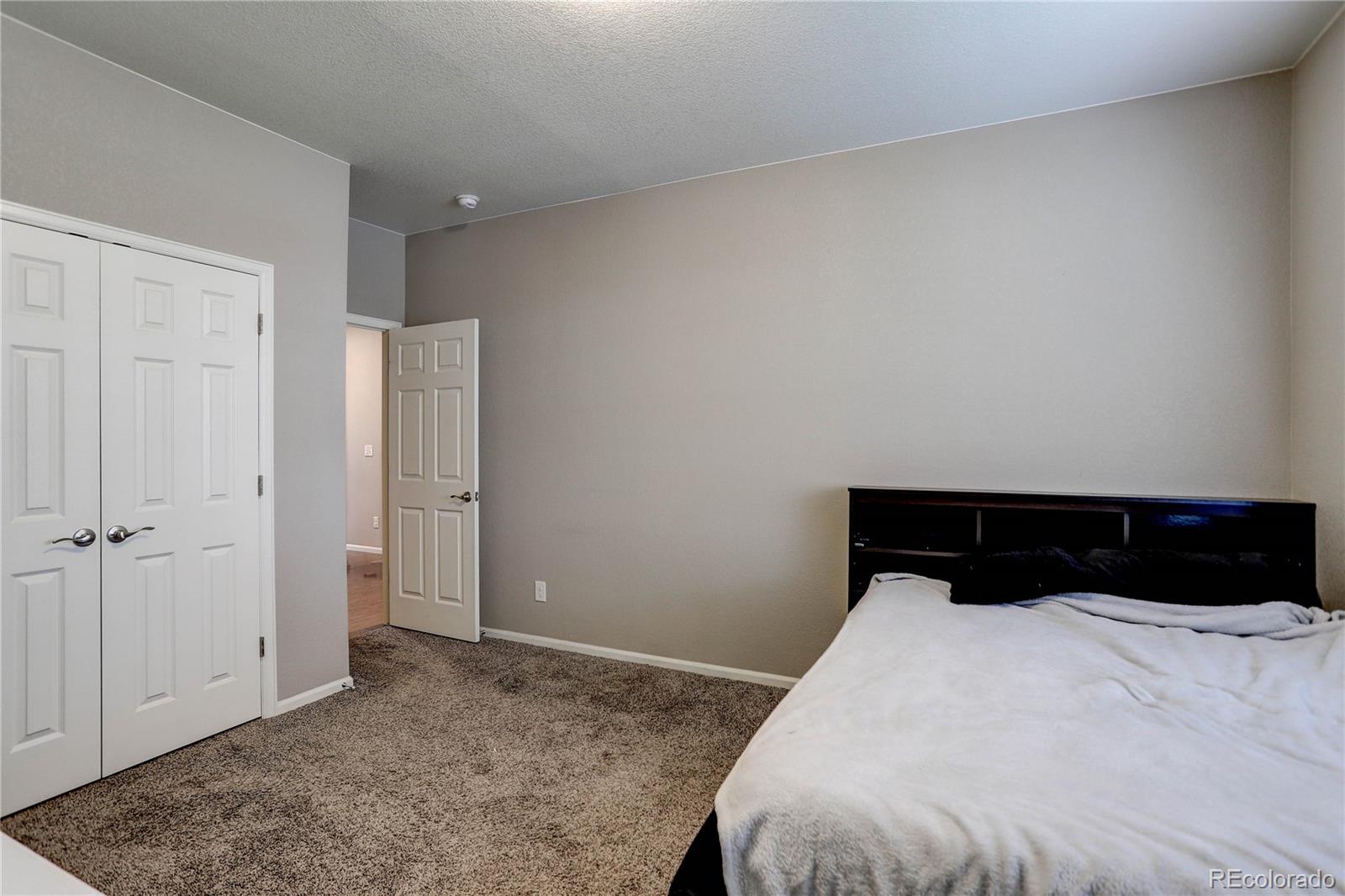 7104 Morrison Drive Frederick, CO 80530 - Photo 14 of 33 a bedroom with a bed and a window