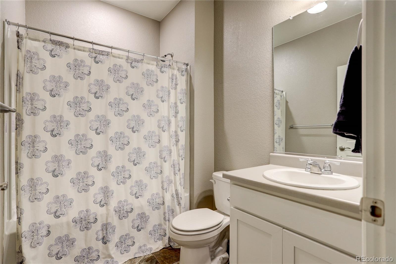 7104 Morrison Drive Frederick, CO 80530 - Photo 15 of 33 a bathroom with a sink toilet and mirror