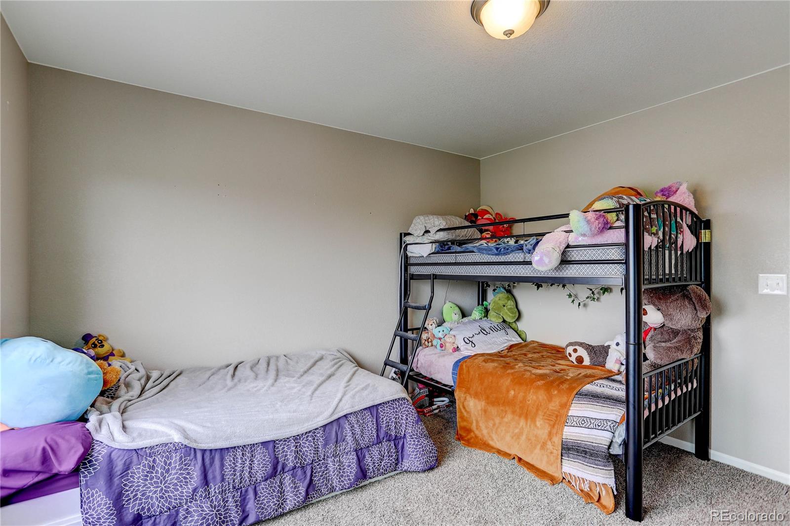 7104 Morrison Drive Frederick, CO 80530 - Photo 17 of 33 a bedroom with two beds and a chandelier