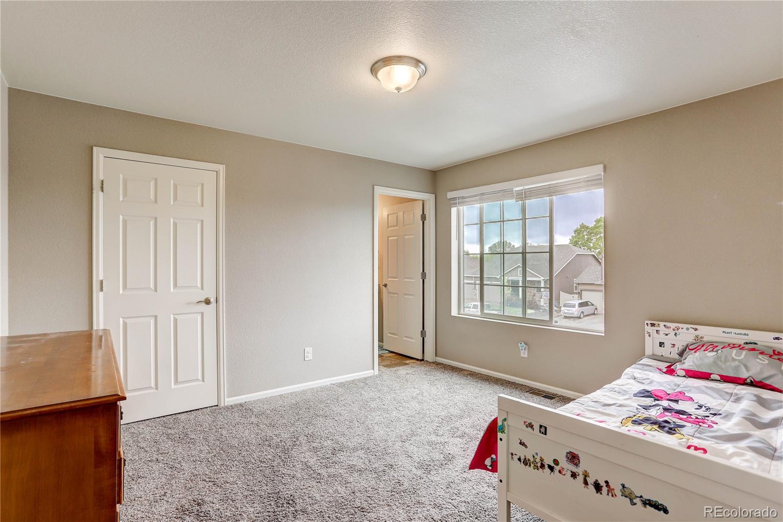 7104 Morrison Drive Frederick, CO 80530 - Photo 20 of 33 a bed room with a bed and a window