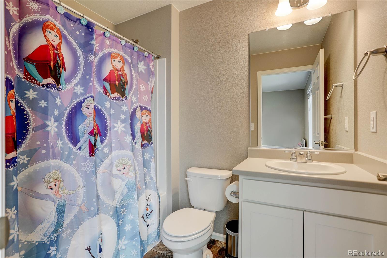 7104 Morrison Drive Frederick, CO 80530 - Photo 21 of 33 a bathroom with a sink mirror vanity and toilet