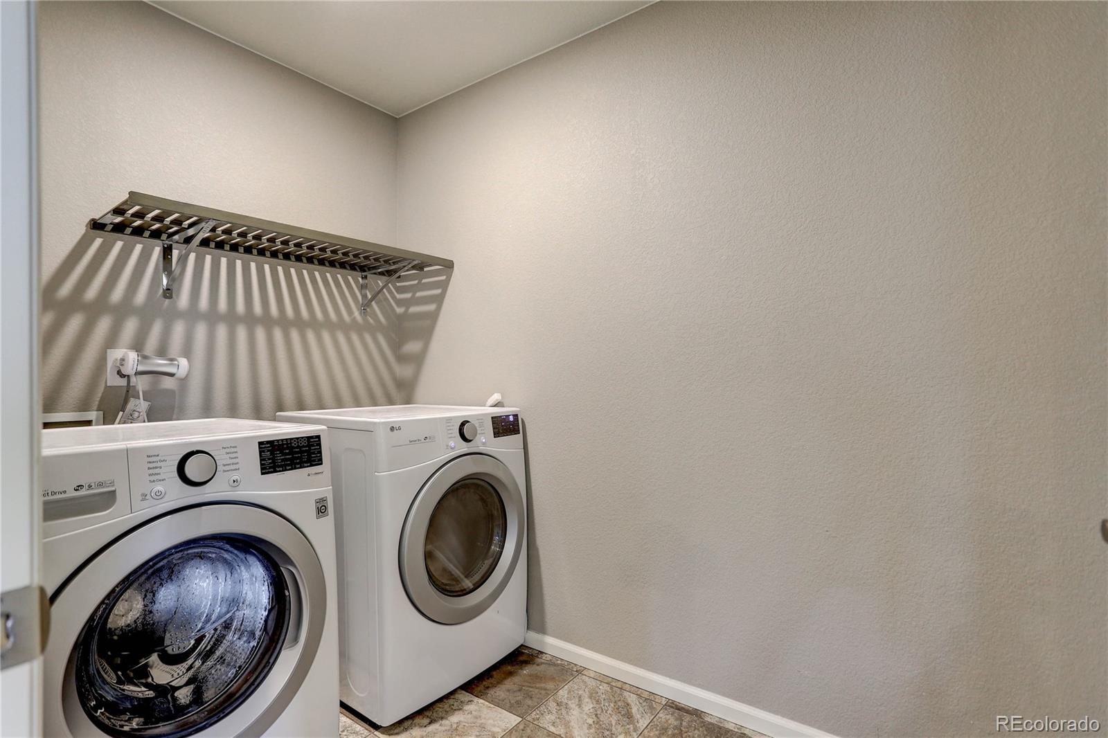 7104 Morrison Drive Frederick, CO 80530 - Photo 22 of 33 a view of storage and utility room with washer and dryer