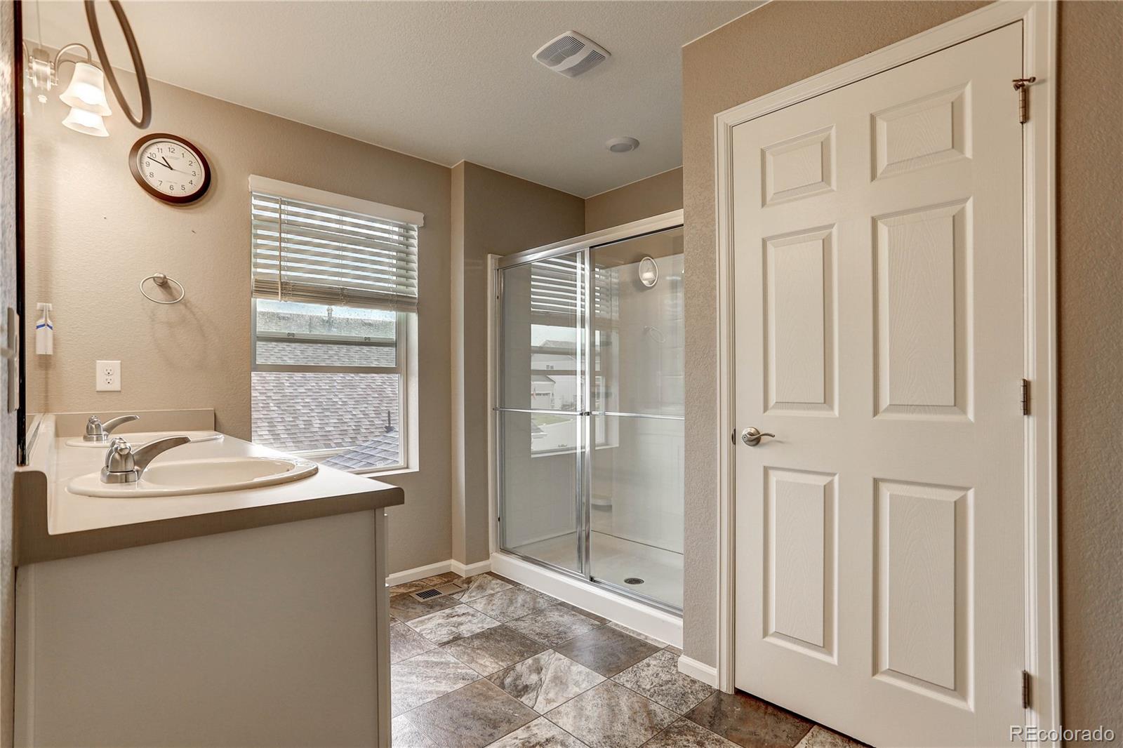 7104 Morrison Drive Frederick, CO 80530 - Photo 25 of 33 a bathroom with a sink and a mirror