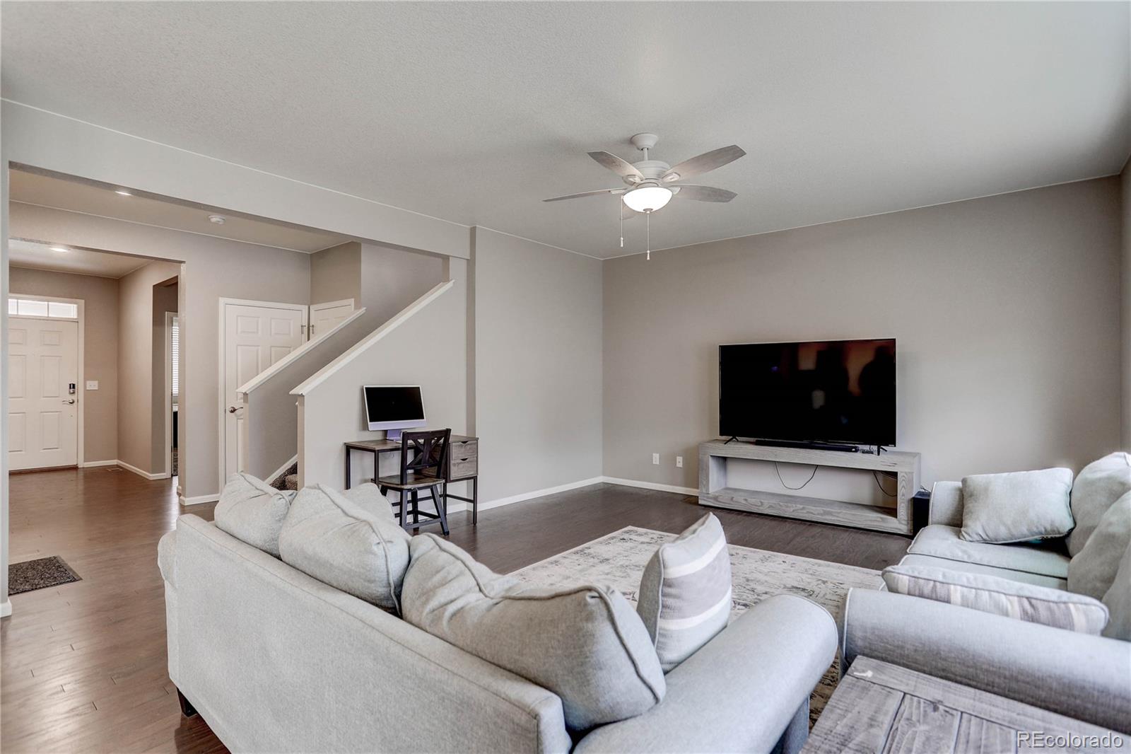 7104 Morrison Drive Frederick, CO 80530 - Photo 3 of 33 a living room with furniture and a flat screen tv