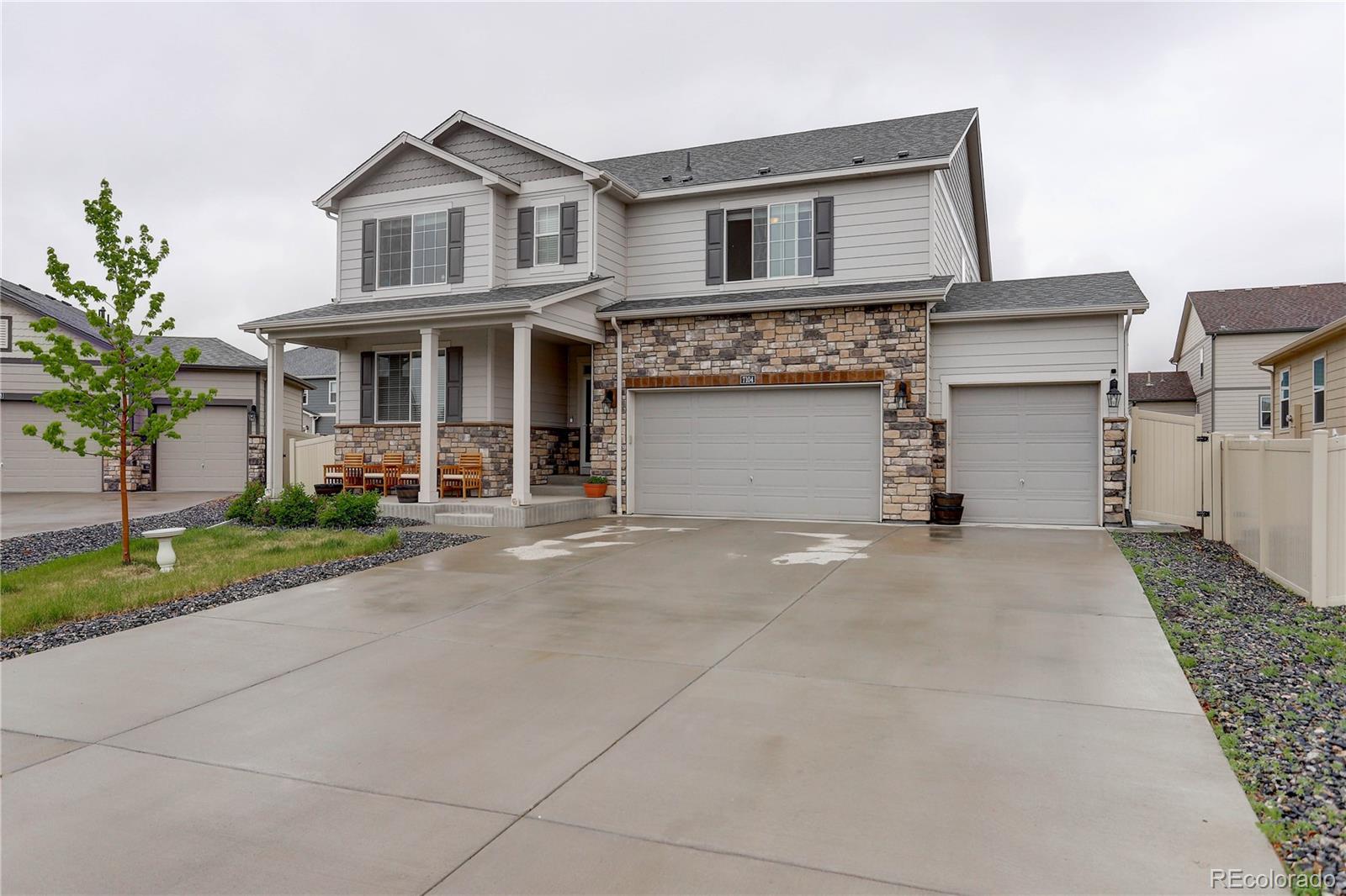 7104 Morrison Drive Frederick, CO 80530 - Photo 31 of 33 a front view of a house with a yard and garage