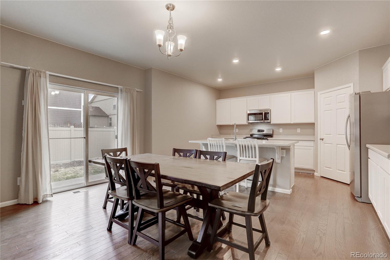 7104 Morrison Drive Frederick, CO 80530 - Photo 6 of 33 a view of a dining room with furniture and wooden floor