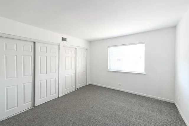 an empty room with a empty space and windows