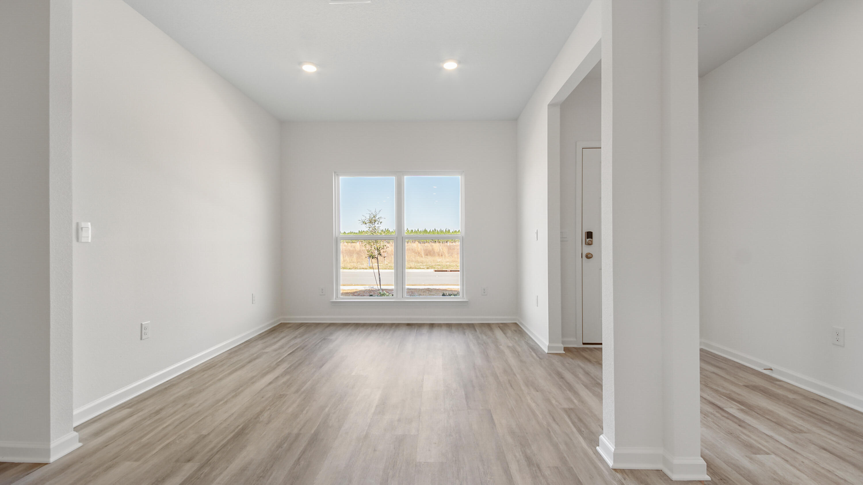 214 Sweetthorn Street Freeport, FL 32439 - Photo 11 of 36 a view of an empty room with wooden floor and a window