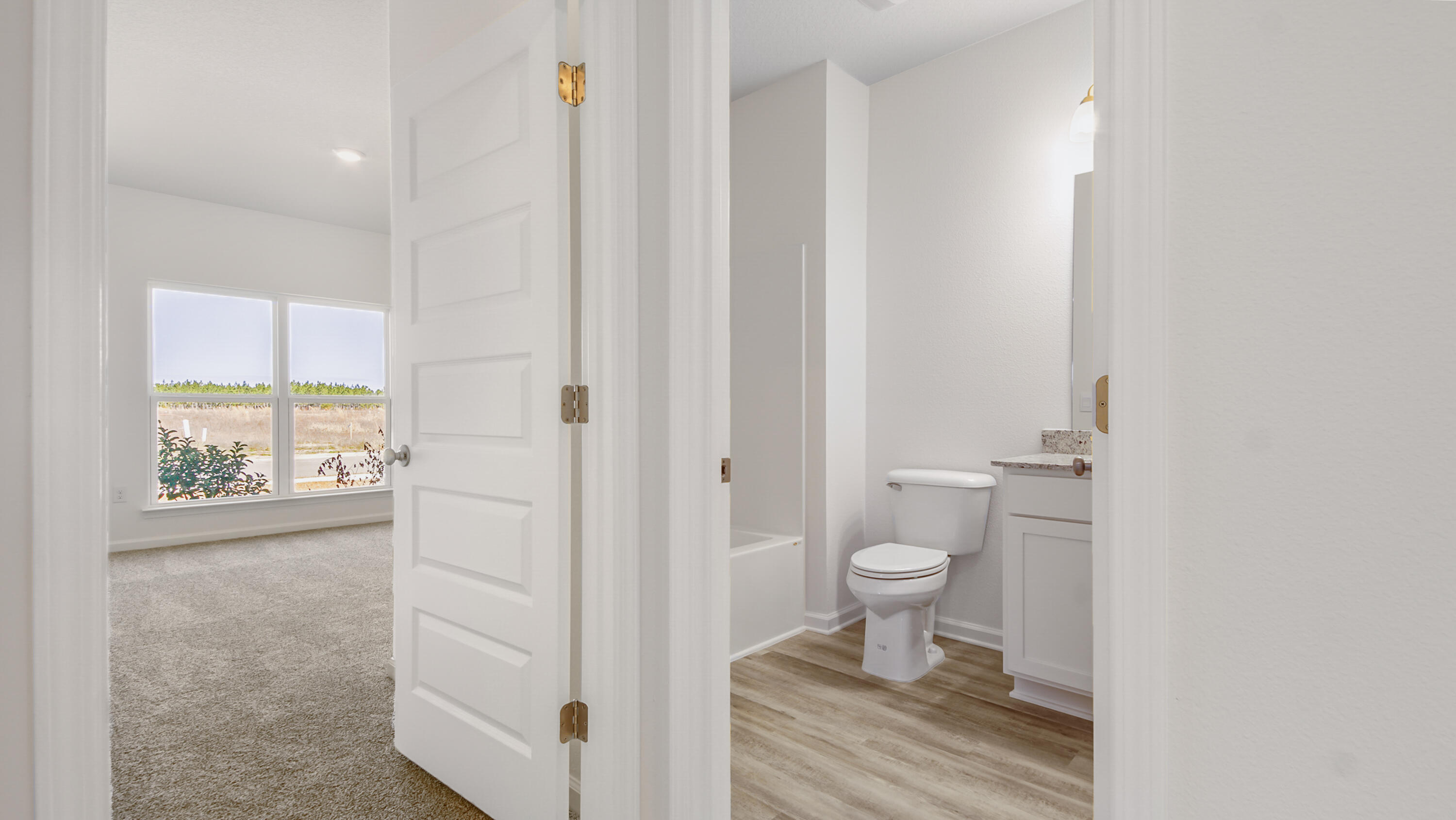 214 Sweetthorn Street Freeport, FL 32439 - Photo 12 of 36 a bathroom with a toilet and a shower curtain