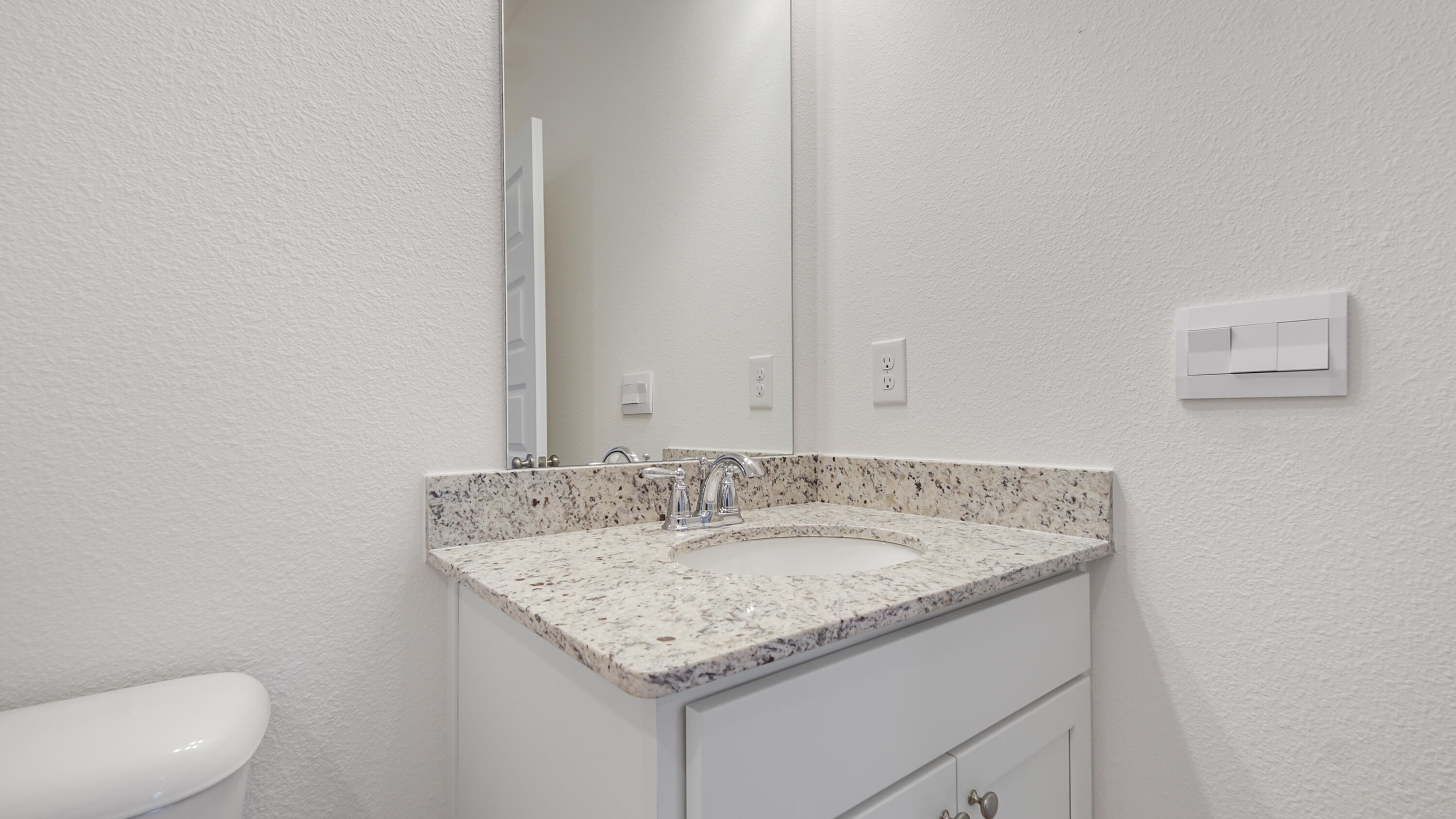 214 Sweetthorn Street Freeport, FL 32439 - Photo 15 of 36 a bathroom with a granite countertop sink and a mirror