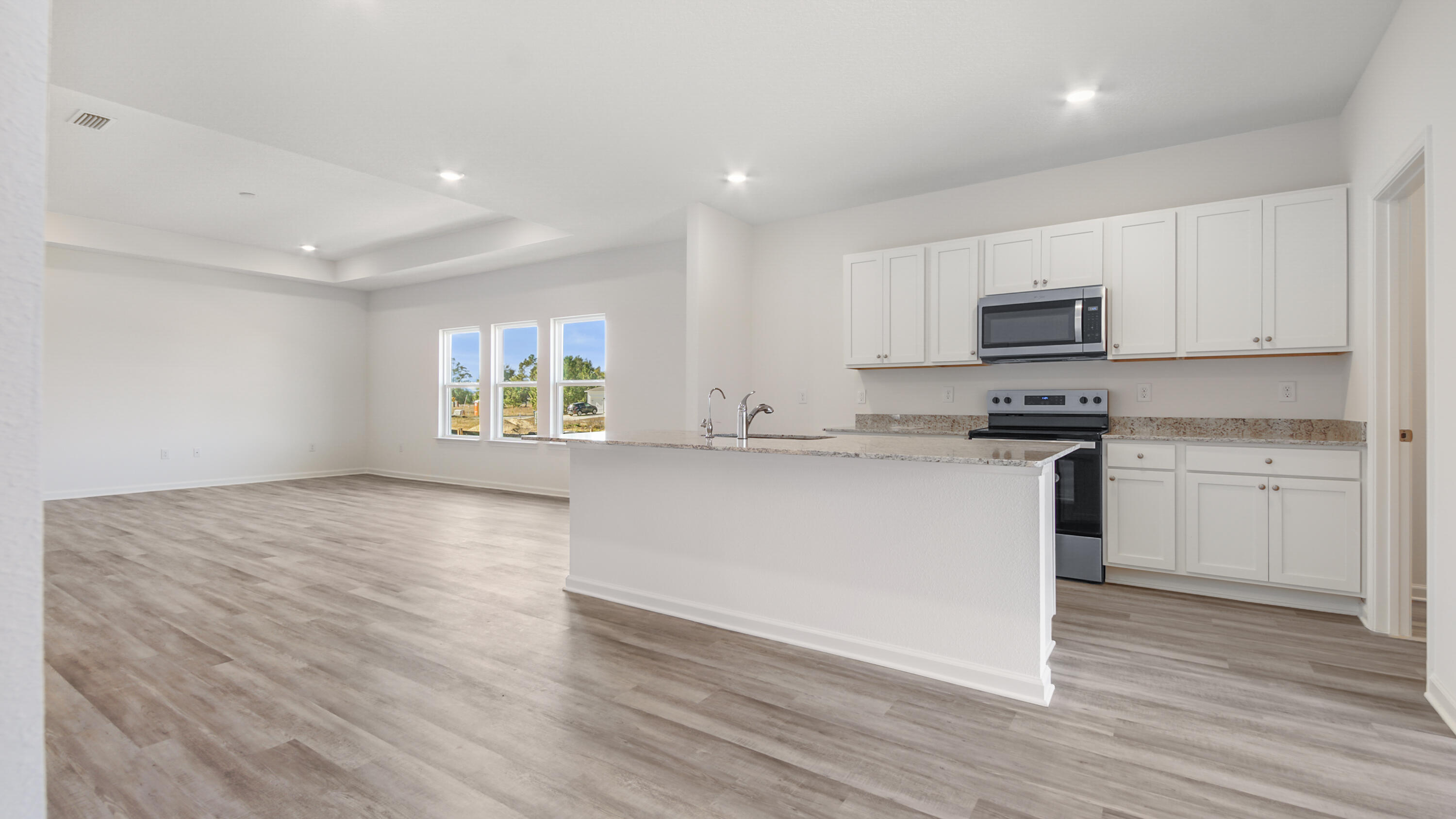 214 Sweetthorn Street Freeport, FL 32439 - Photo 5 of 36 a kitchen with granite countertop white cabinets and white appliances