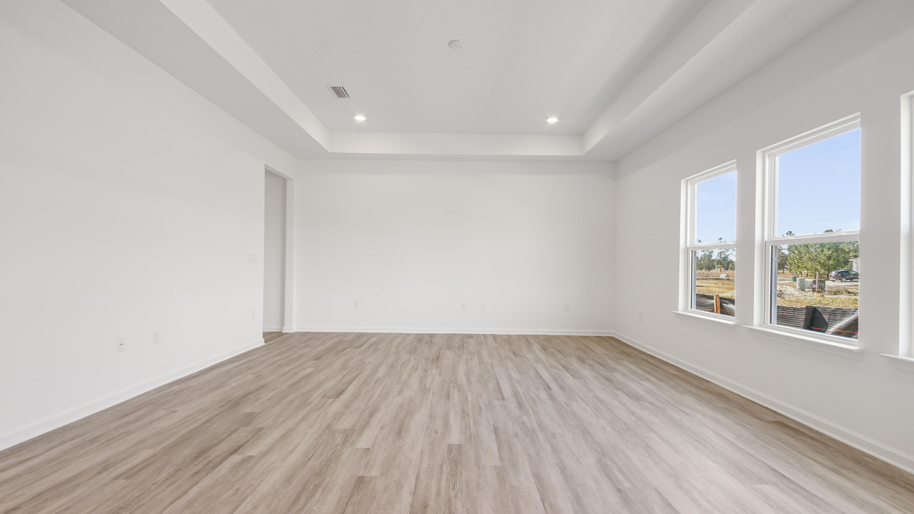 214 Sweetthorn Street Freeport, FL 32439 - Photo 6 of 36 an empty room with wooden floor and windows