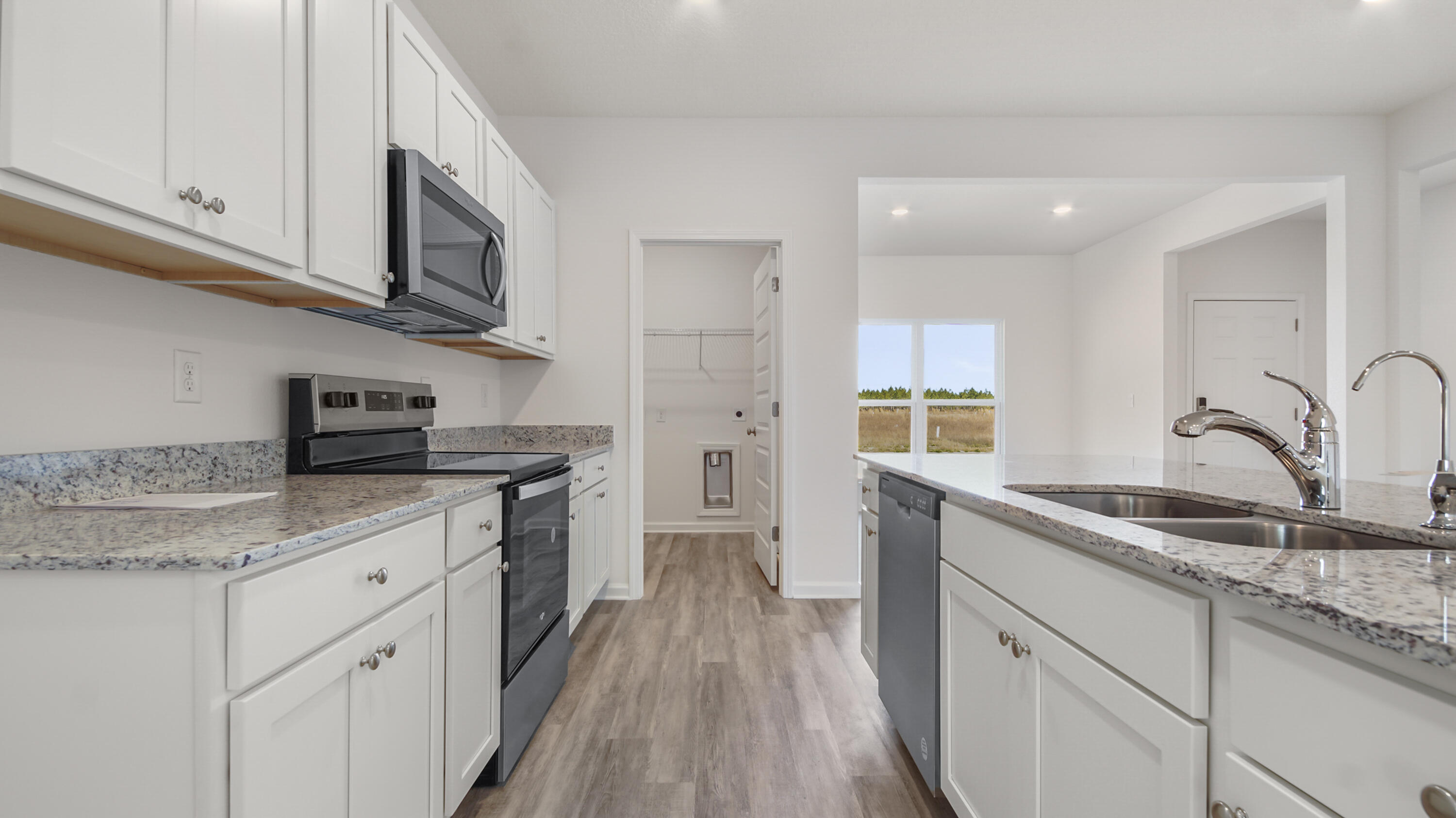 214 Sweetthorn Street Freeport, FL 32439 - Photo 8 of 36 a kitchen with stainless steel appliances granite countertop a sink stove and cabinets