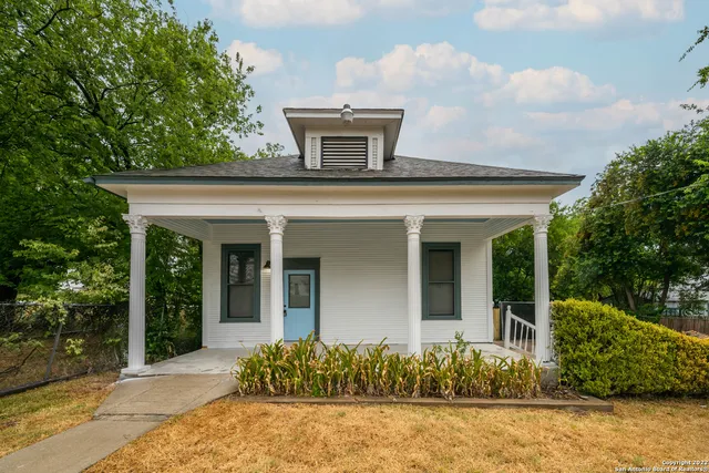 front view of a house with a potted plant