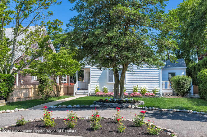 209 Howe Street Point Pleasant, NJ 08742 - Photo 3 of 27 a front view of a house with a yard and a garage