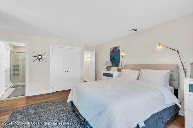 209 Howe Street Point Pleasant, NJ 08742 - Photo 22 of 27 a bedroom with a bed and wooden floor