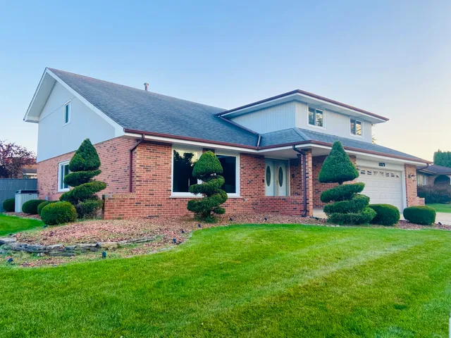 a front view of a house with a yard and garage