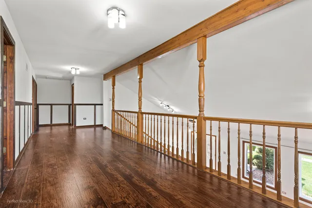 a view of hallway with wooden floor