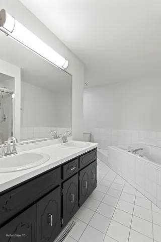 a bathroom with a bathtub sink vanity and mirror