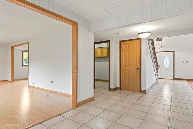 a view of a hallway with wooden floor and closet