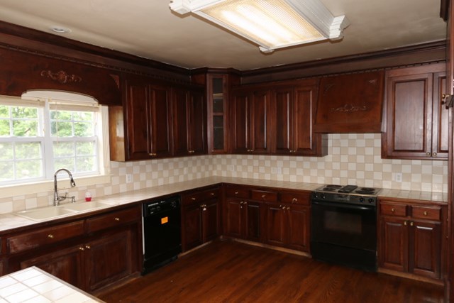 157 Gates Road Lizella, GA 31052 - Photo 12 of 30 a kitchen with stainless steel appliances wooden cabinets a sink and a stove