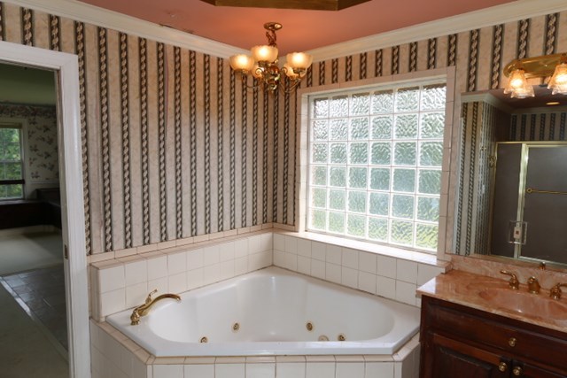 157 Gates Road Lizella, GA 31052 - Photo 21 of 30 a bathroom with a bathtub and a shower