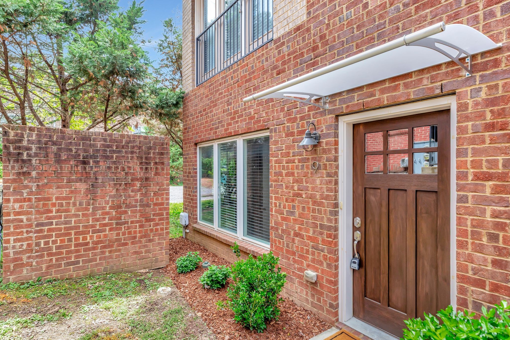 2003 Convent Place, Unit 9 Nashville, TN 37212 - Photo 2 of 31 front view of a brick house with a large windows