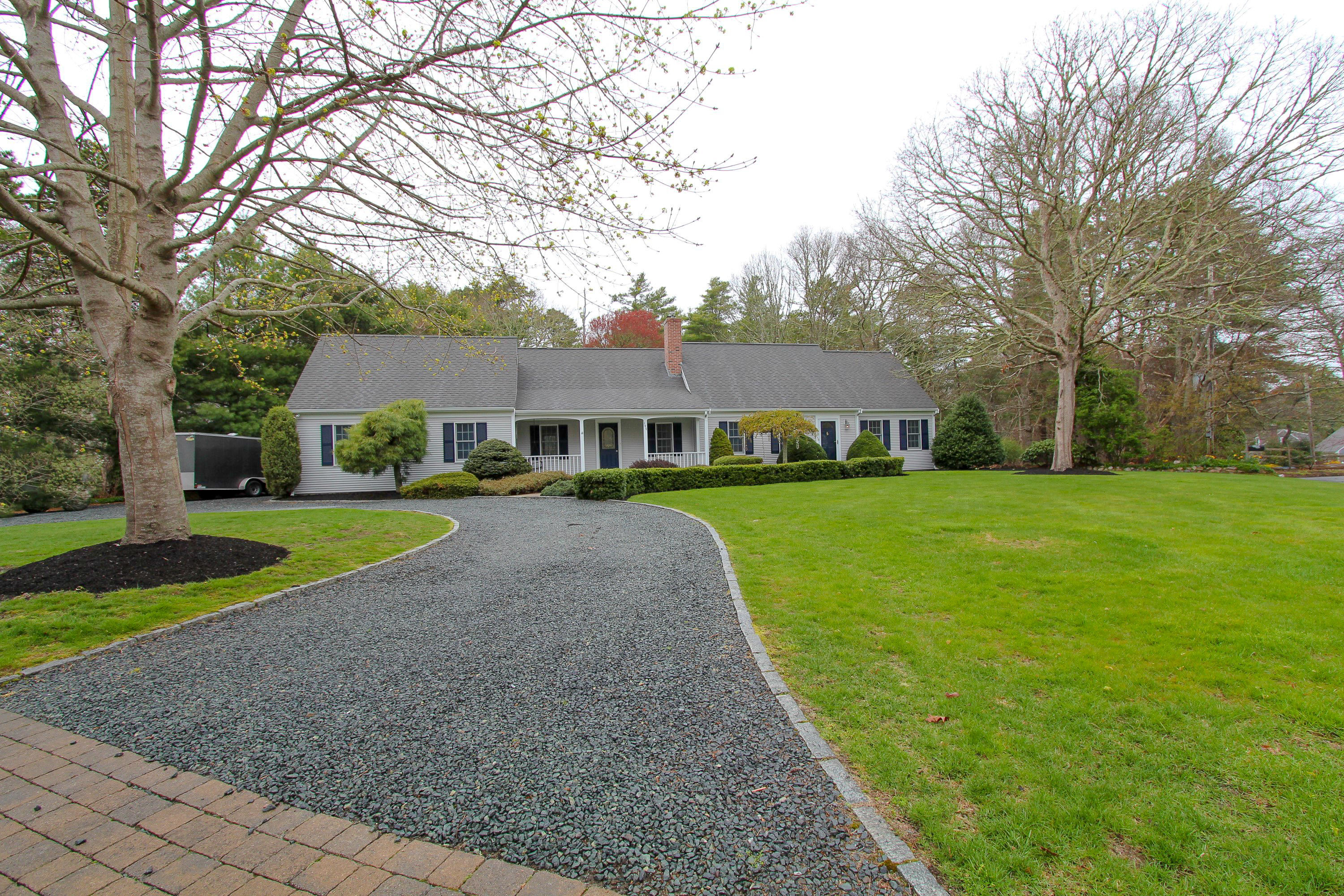 199 Skunknet Road Centerville, MA 02632 - Photo 1 of 37 a view of house with a big yard and large trees