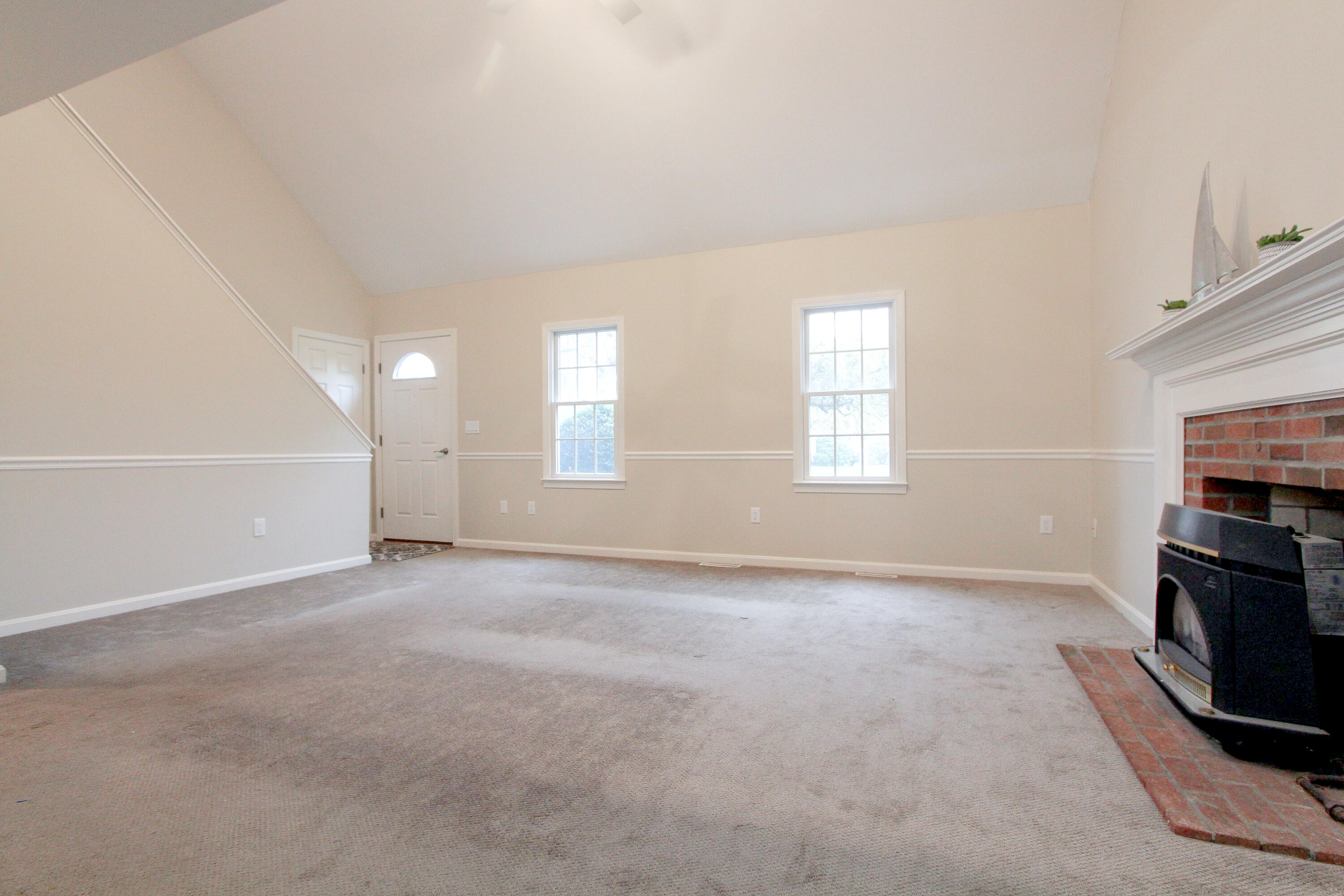 199 Skunknet Road Centerville, MA 02632 - Photo 13 of 37 an empty room with windows and fireplace