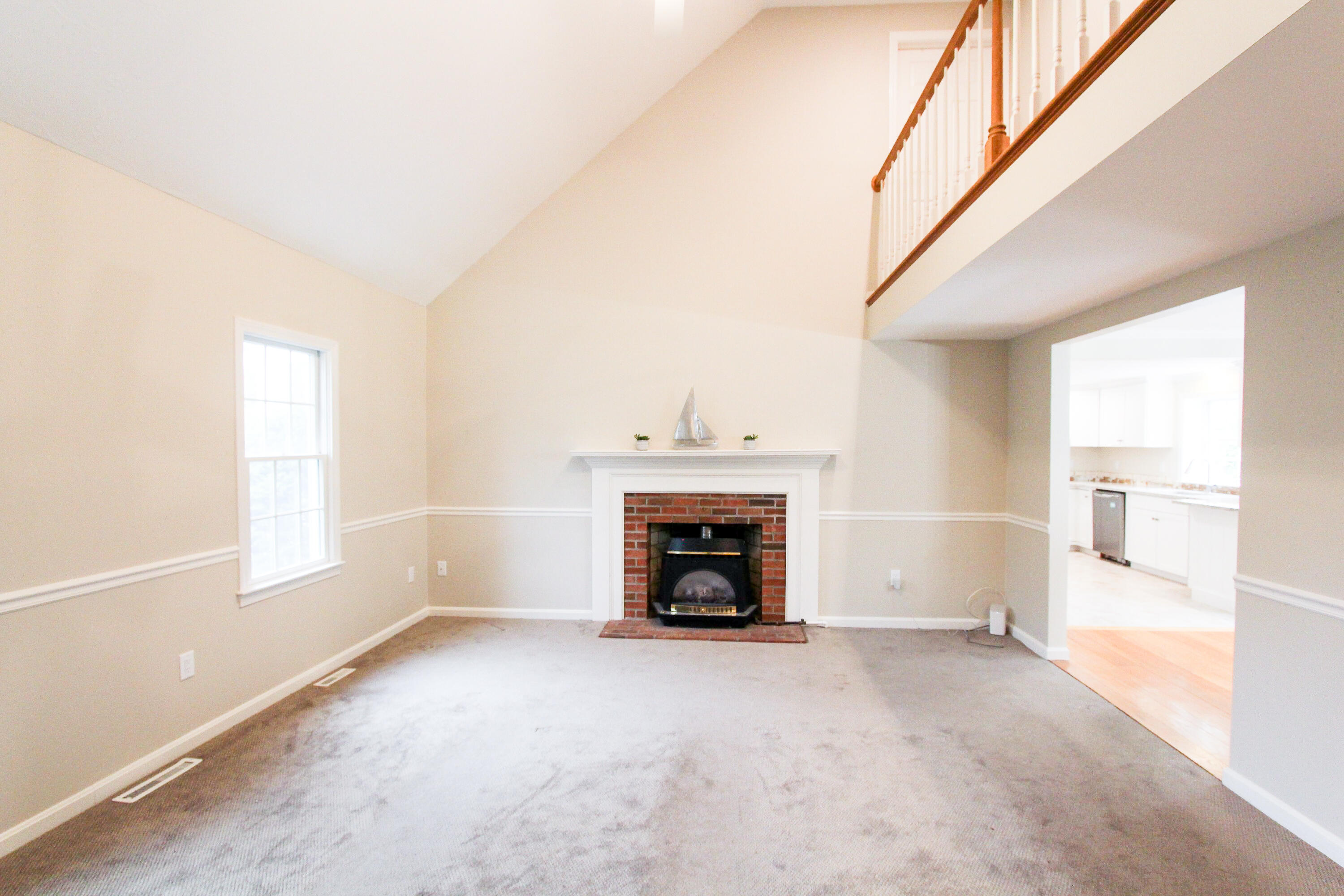 199 Skunknet Road Centerville, MA 02632 - Photo 14 of 37 a view of an empty room with a window and fireplace