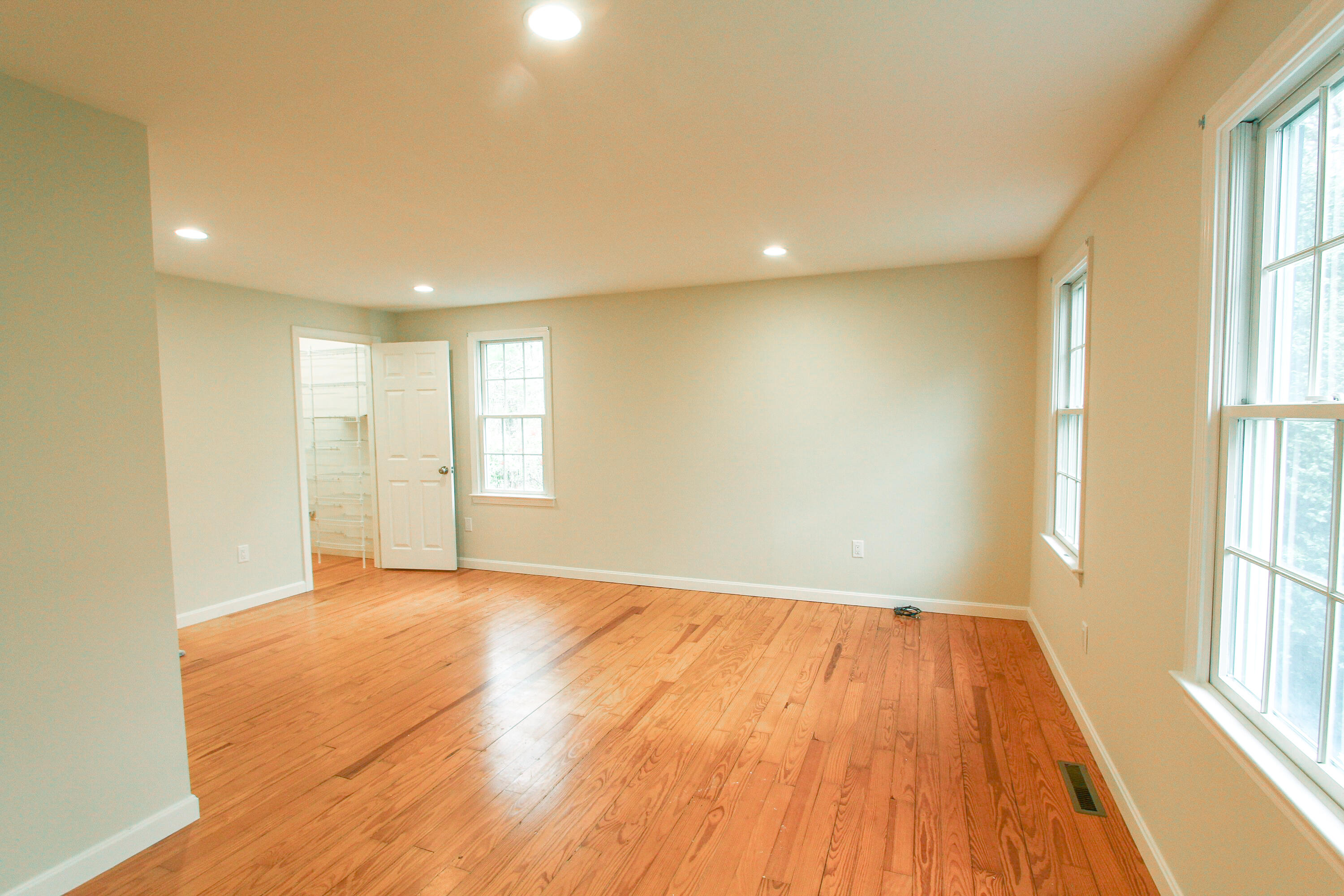 199 Skunknet Road Centerville, MA 02632 - Photo 16 of 37 a view of an empty room with wooden floor and a window
