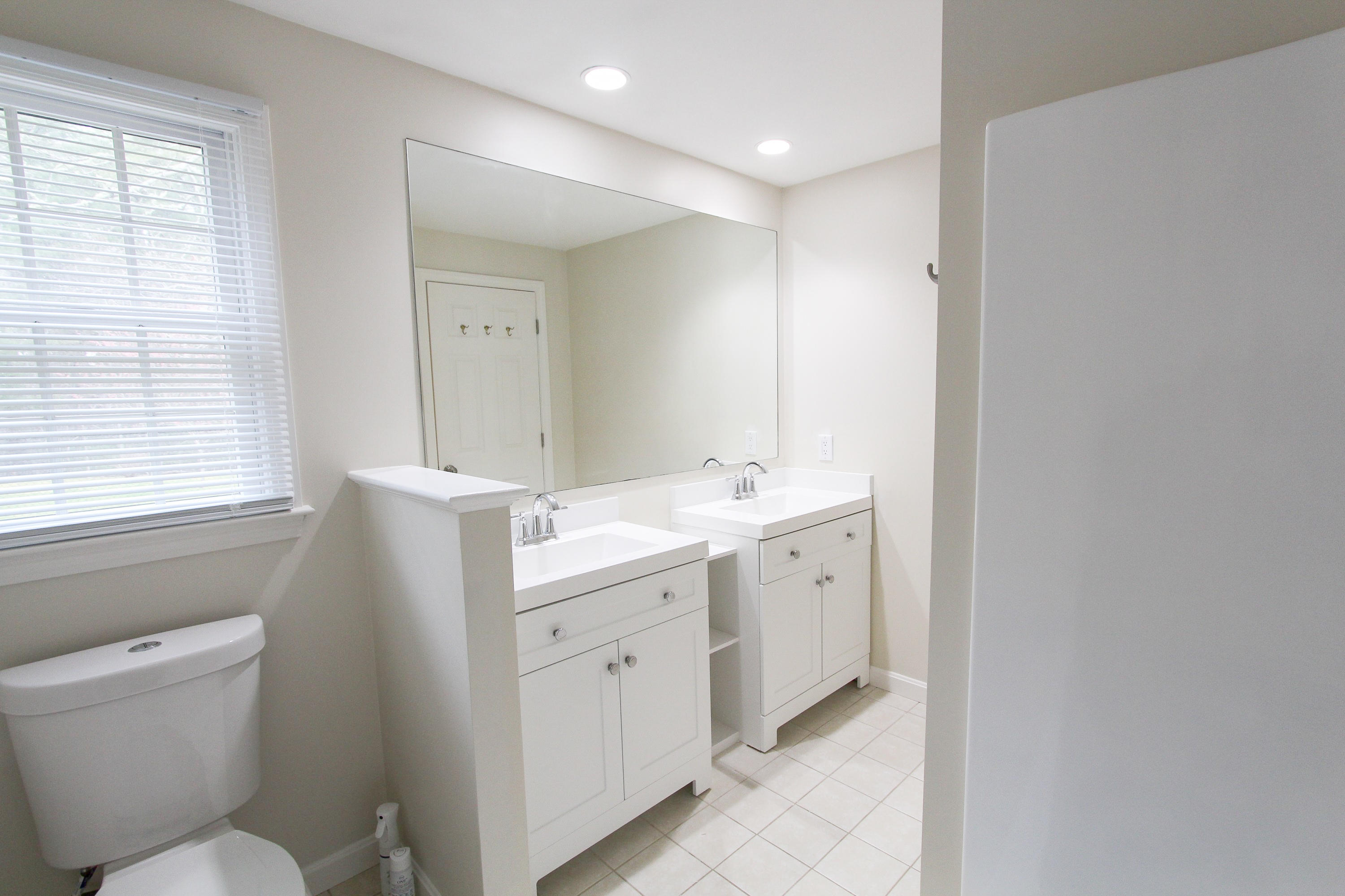 199 Skunknet Road Centerville, MA 02632 - Photo 22 of 37 a spacious bathroom with a toilet sink and mirror