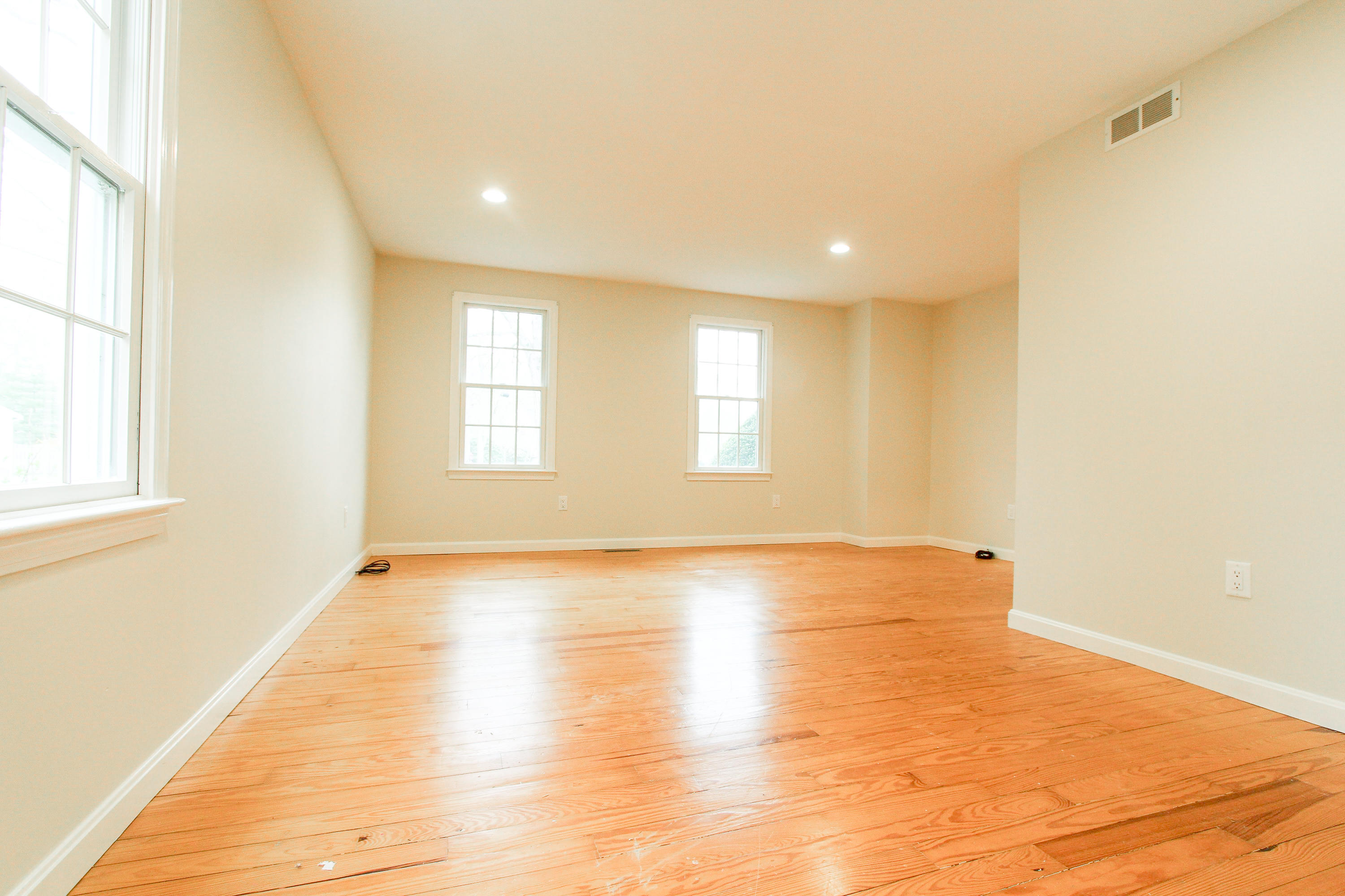 199 Skunknet Road Centerville, MA 02632 - Photo 23 of 37 a view of an empty room with wooden floor and a window