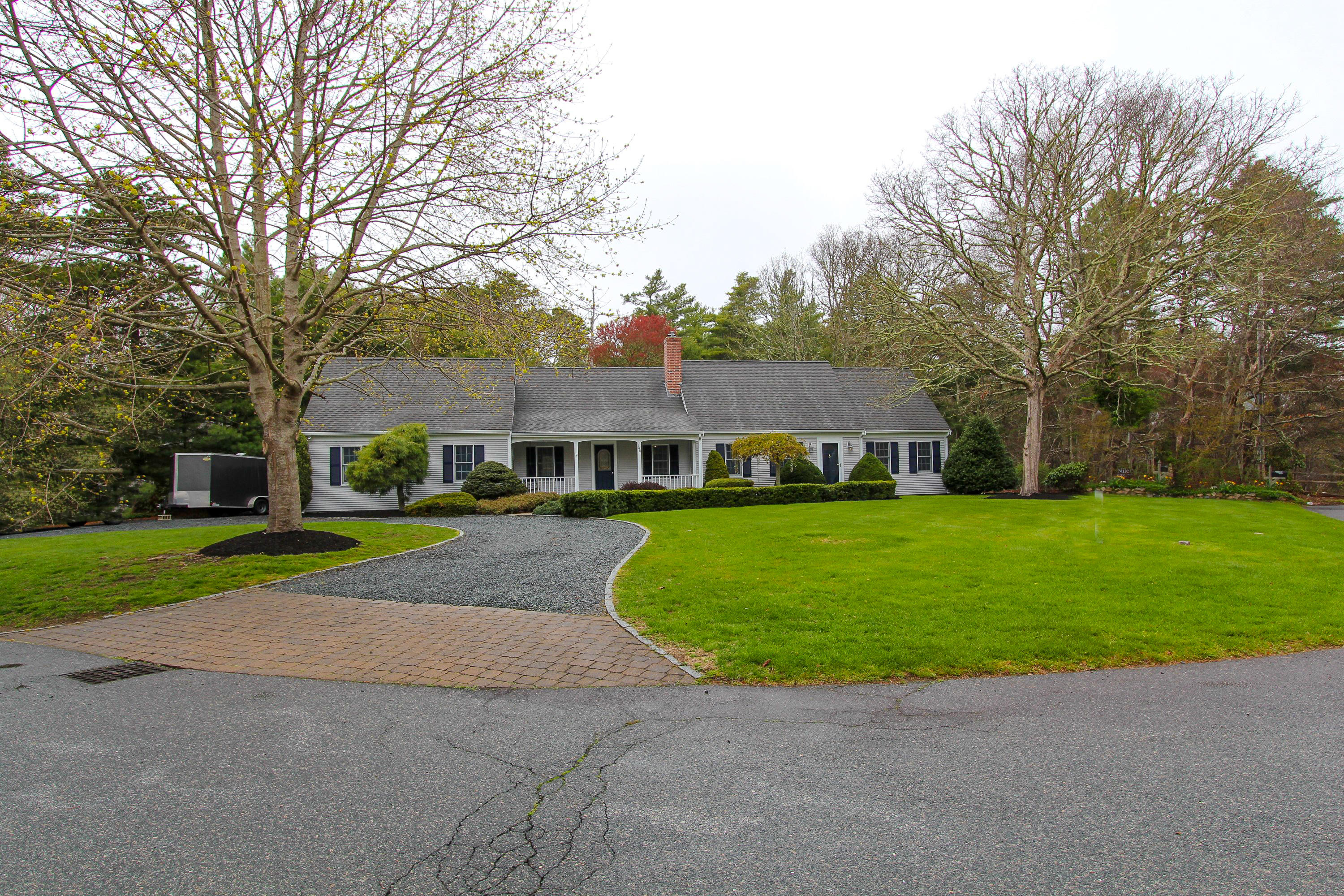 199 Skunknet Road Centerville, MA 02632 - Photo 34 of 37 a front view of a house with a yard and trees