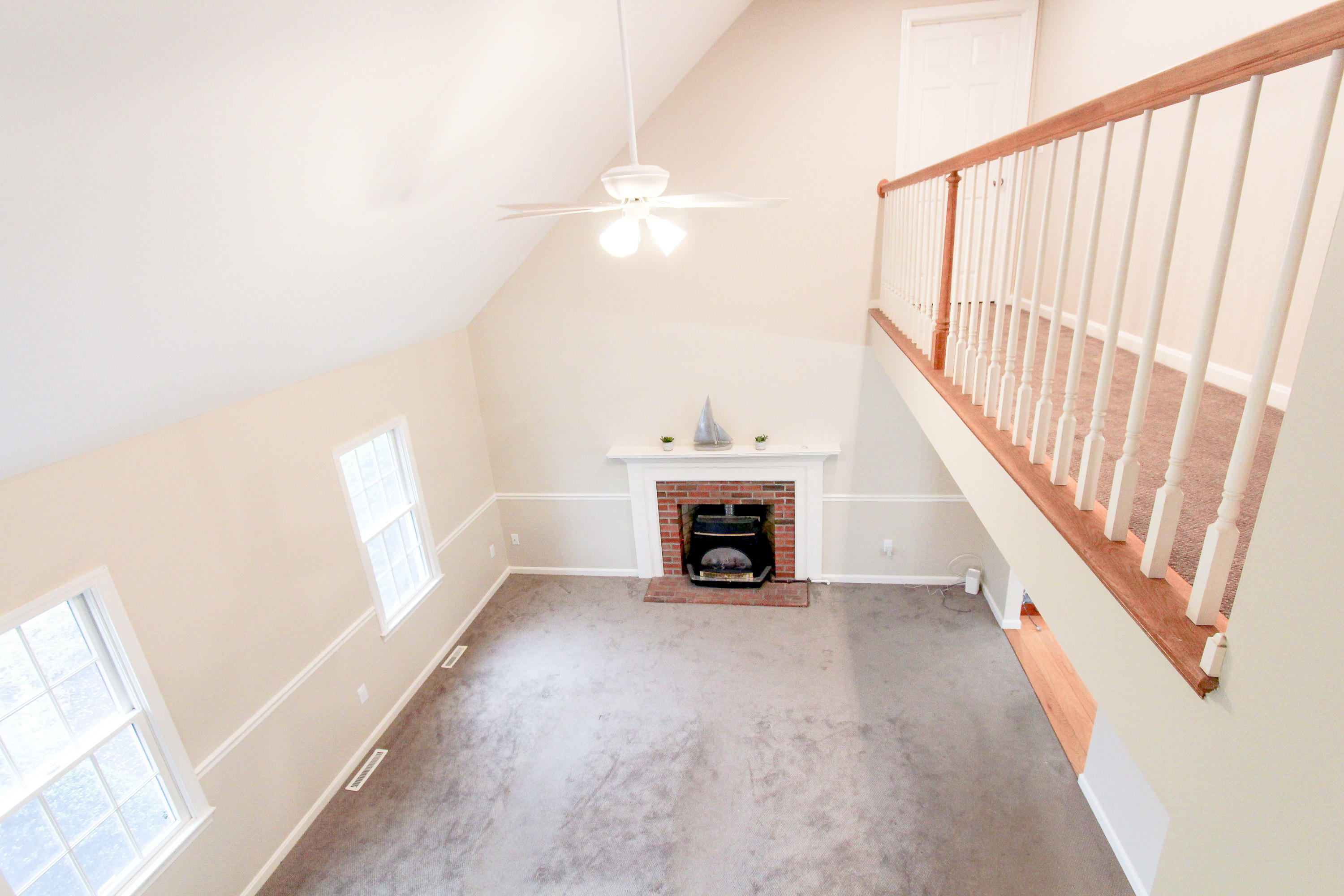 199 Skunknet Road Centerville, MA 02632 - Photo 5 of 37 a view of an empty room with a fireplace