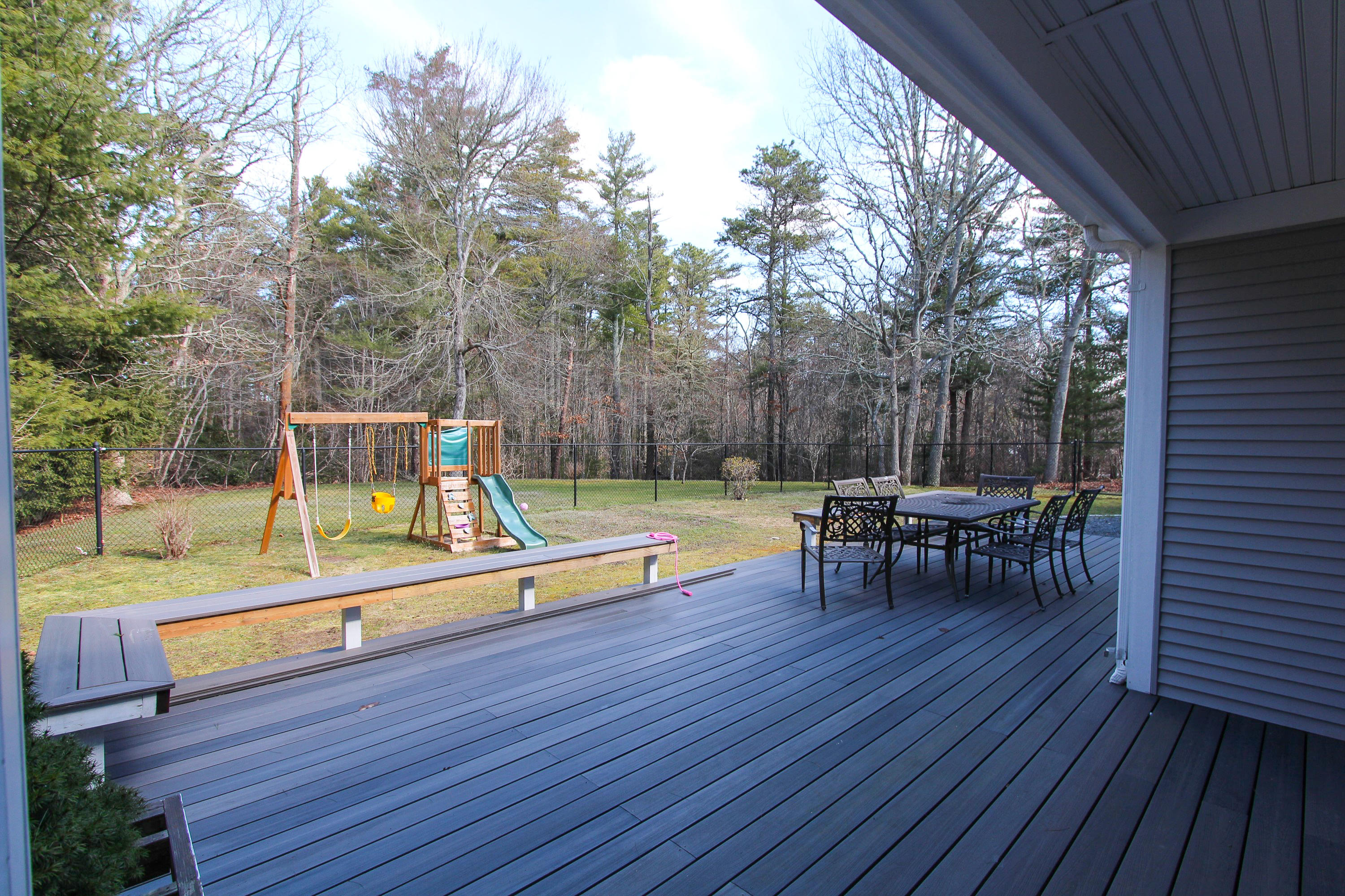 199 Skunknet Road Centerville, MA 02632 - Photo 6 of 37 a view of a chairs and tables in the back yard of the house