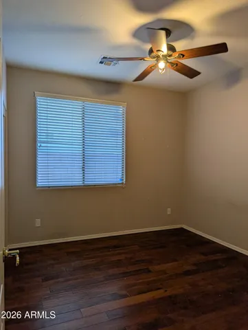 a view of a room with wooden floor and fan