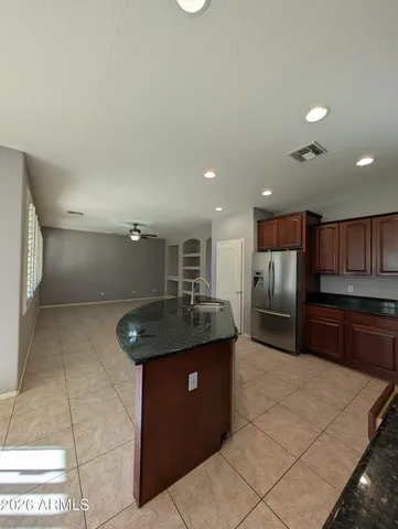 a kitchen with stainless steel appliances granite countertop a sink counter space cabinets and a view of kitchen