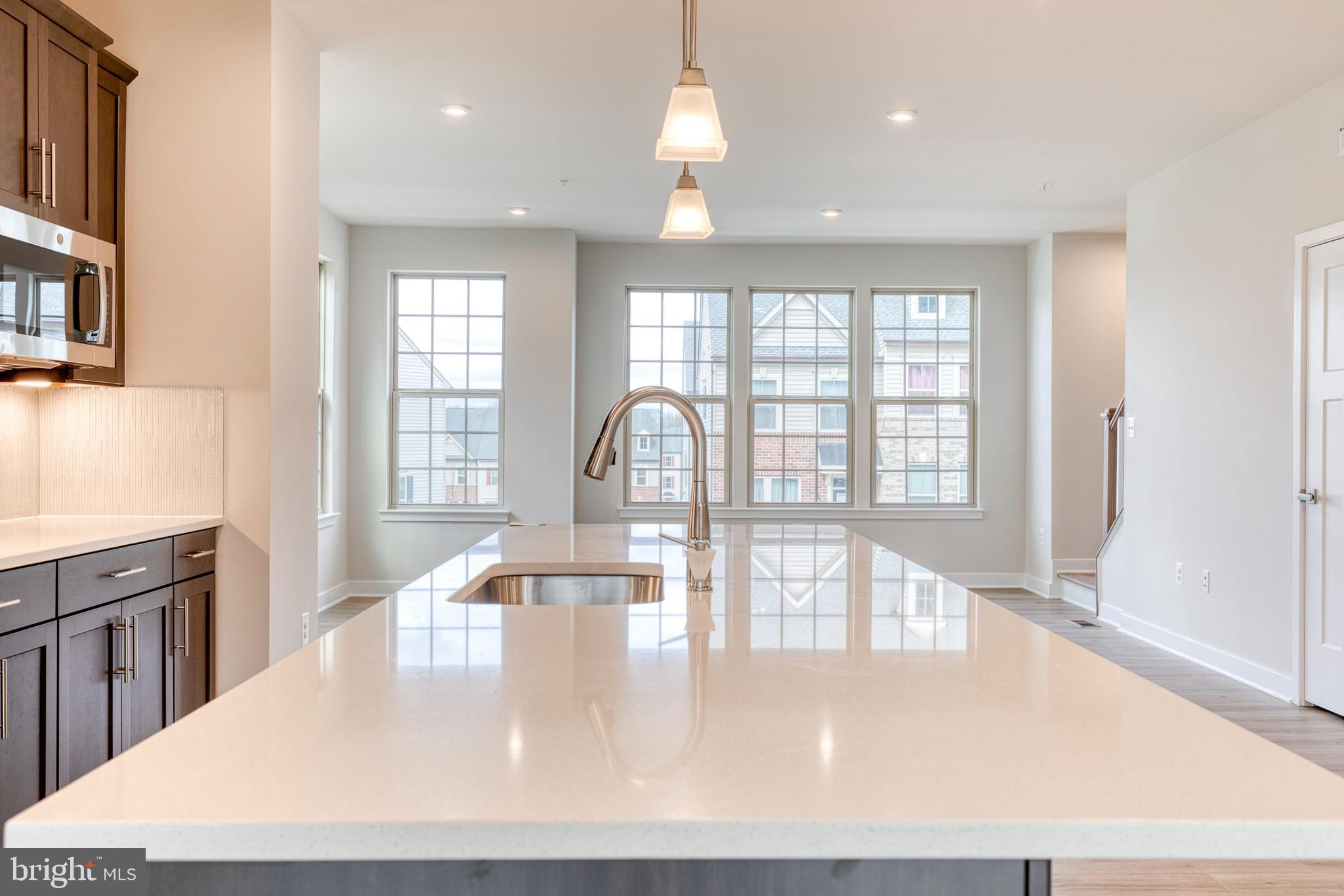 3433 Jacobs Ford Way Hanover, MD 21076 - Photo 11 of 37 a view of a kitchen with a dining table chairs and window