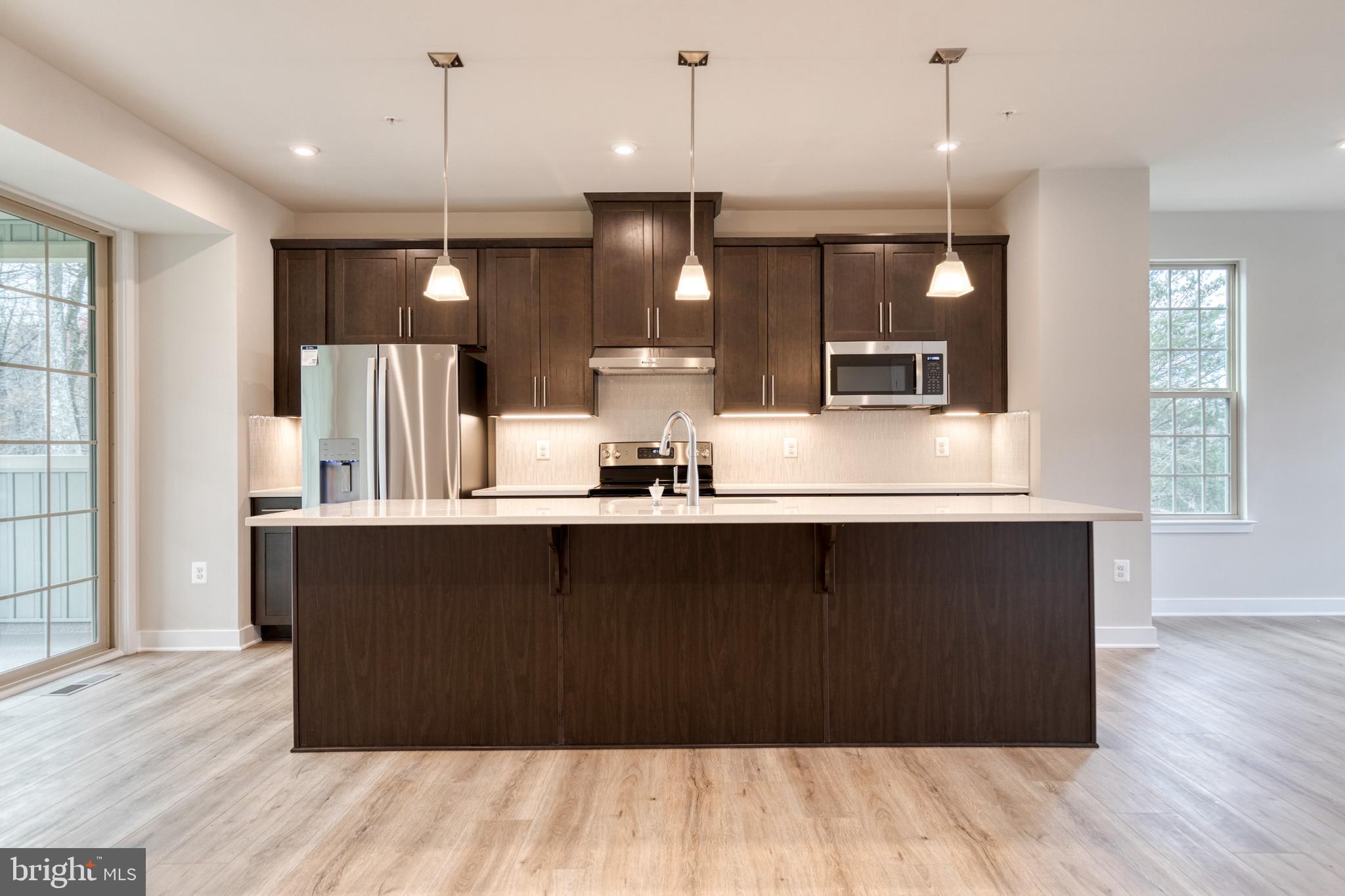 3433 Jacobs Ford Way Hanover, MD 21076 - Photo 15 of 37 a kitchen with a sink cabinets and wooden floor