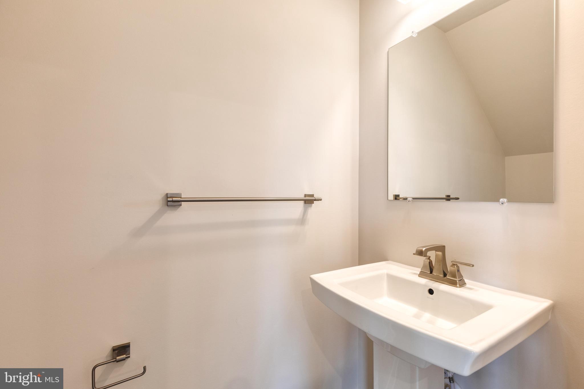 3433 Jacobs Ford Way Hanover, MD 21076 - Photo 20 of 37 a bathroom with a sink a mirror and shower