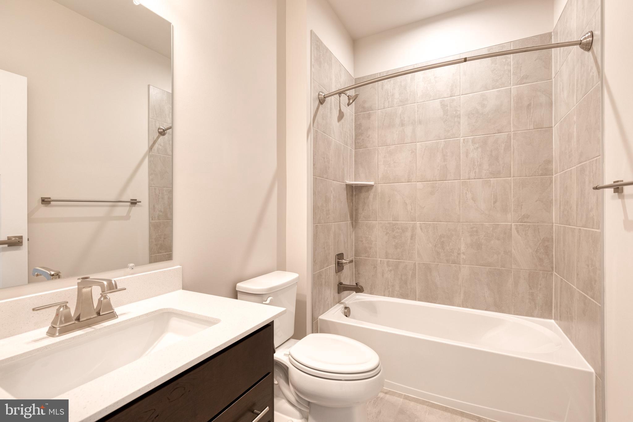 3433 Jacobs Ford Way Hanover, MD 21076 - Photo 30 of 37 a bathroom with a sink a toilet a mirror a bathtub and shower