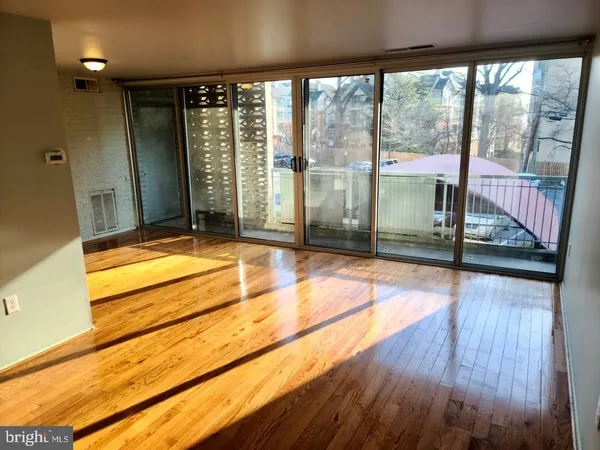 a view of a living room and floor to ceiling window or wooden floor