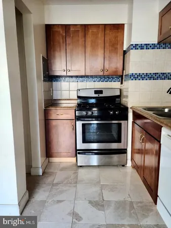 a stove top oven sitting inside of a kitchen