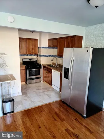 a kitchen with stainless steel appliances a refrigerator and a stove top oven